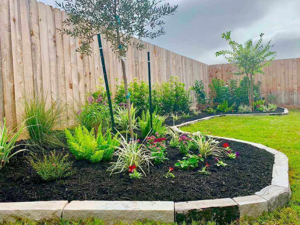 Fresh mulch bed with decorative stone and planting detail showing the type of bed refresh and cleanup work Steel Harbor Yardworks can quote.